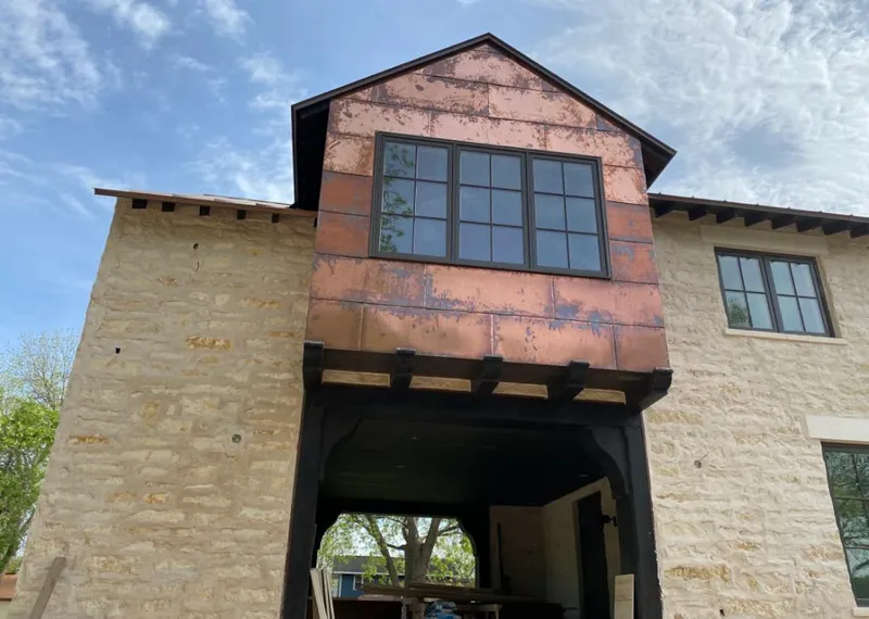 Copper metal panel facade on a stone building for Skylight Installation in La Puente